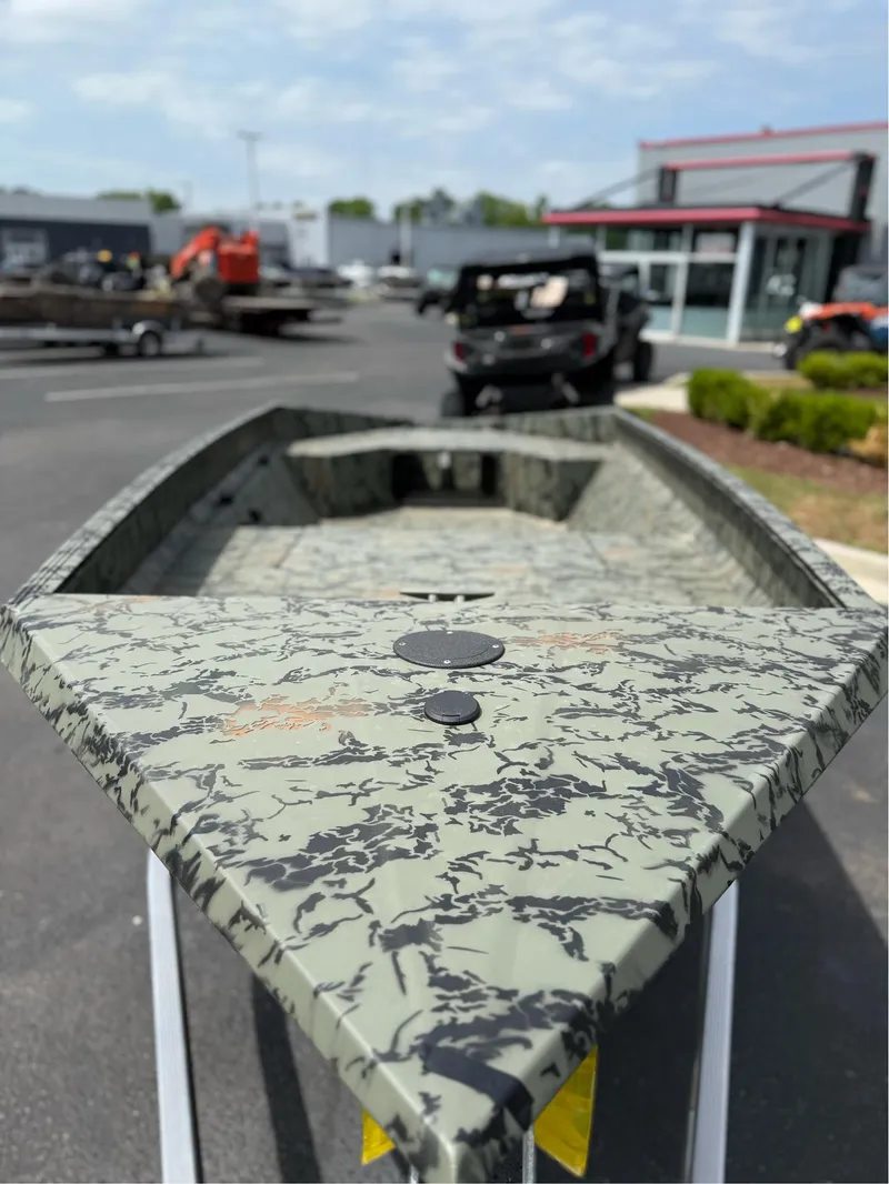 Slide: The Image of 2025 EDGE BOATS 656DB with camouflage design, displayed outdoors on a sunny day. - 9