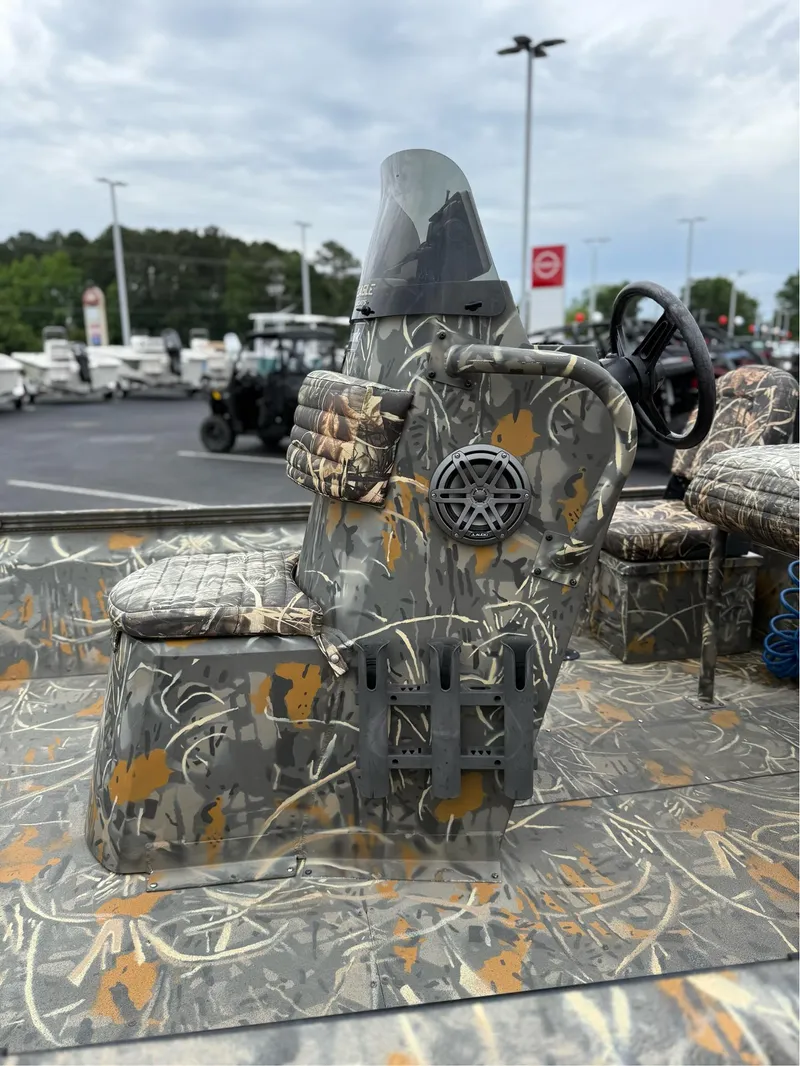 Slide: The Image of 2022 War Eagle 961 Blackhawk boat with camouflage design and steering console. - 10