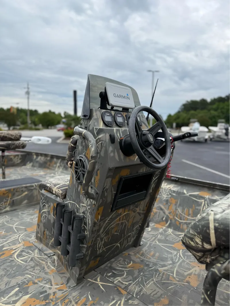 Slide: The Image of 2022 War Eagle 961 Blackhawk boat console with camouflage design and Garmin navigation system. - 12