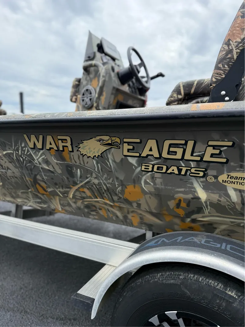 Slide: The Image of 2022 War Eagle 961 Blackhawk boat with camouflage design on a trailer. - 13
