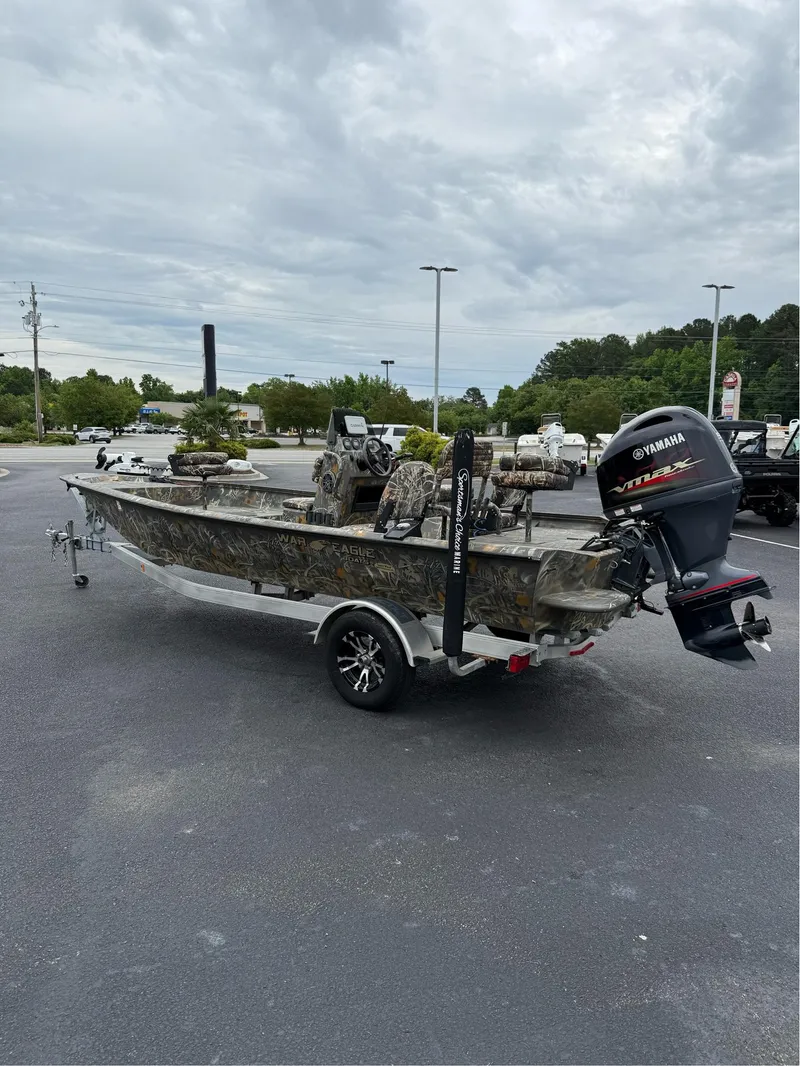 Slide: The Image of 2022 War Eagle 961 Blackhawk boat with Yamaha outboard motor in a parking lot. - 16