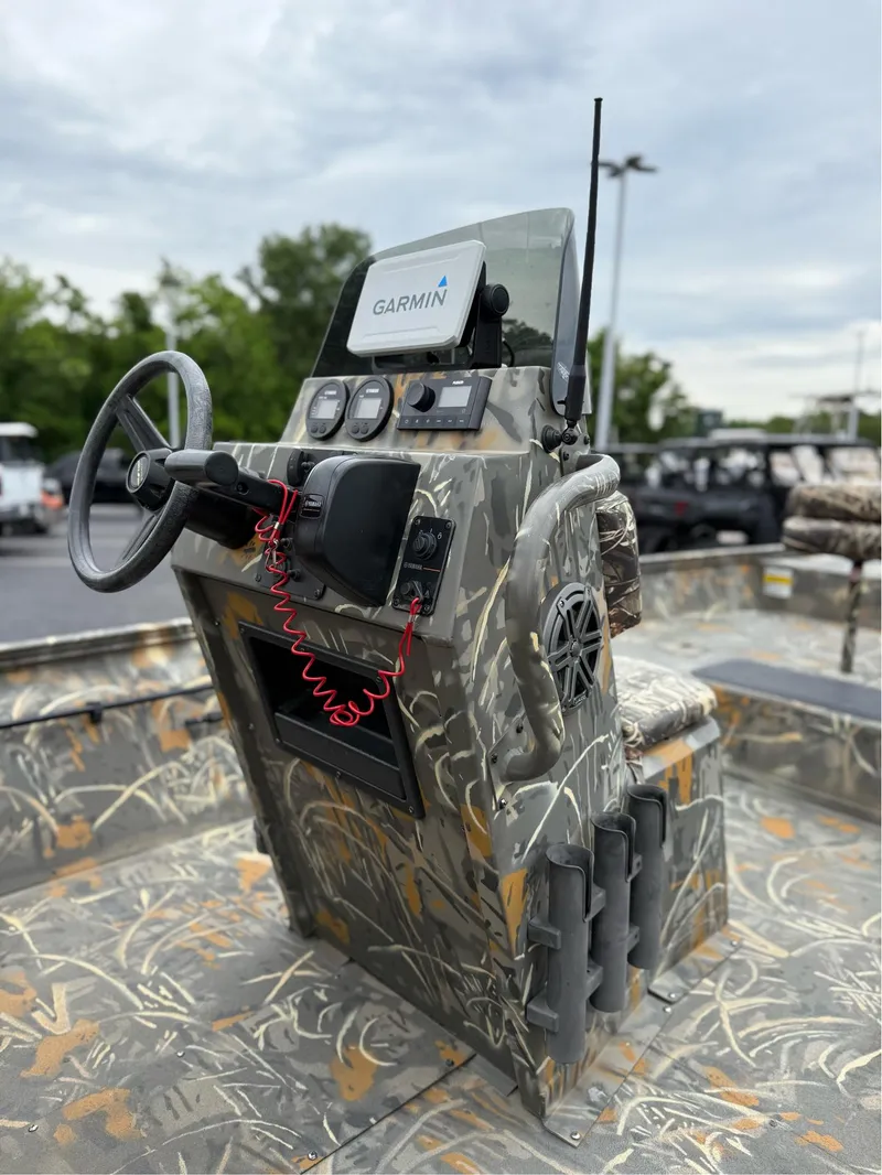 Slide: The Image of 2022 War Eagle 961 Blackhawk boat console with camouflage design and Garmin navigation system. - 19