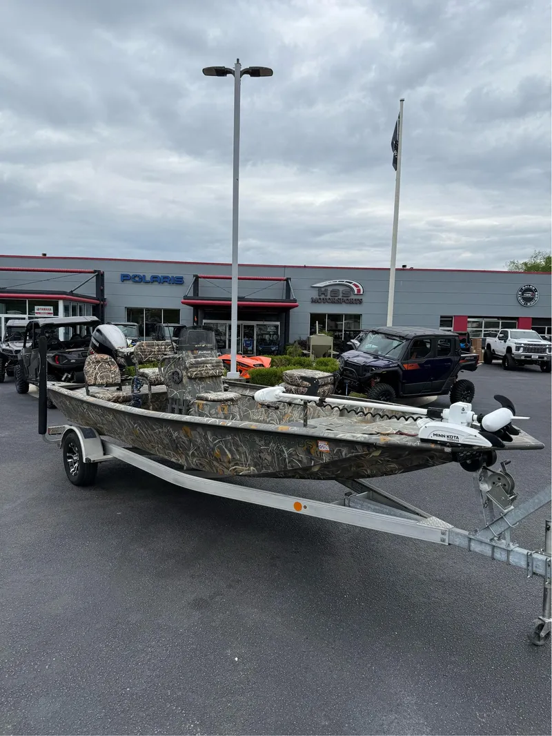 Slide: The Image of 2022 War Eagle 961 Blackhawk boat on trailer at dealership, overcast sky. - 2