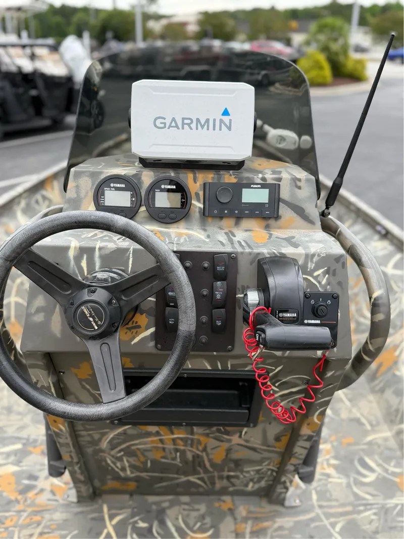 Slide: The Image of 2022 War Eagle 961 Blackhawk boat dashboard with Garmin navigation system and Yamaha controls. - 21