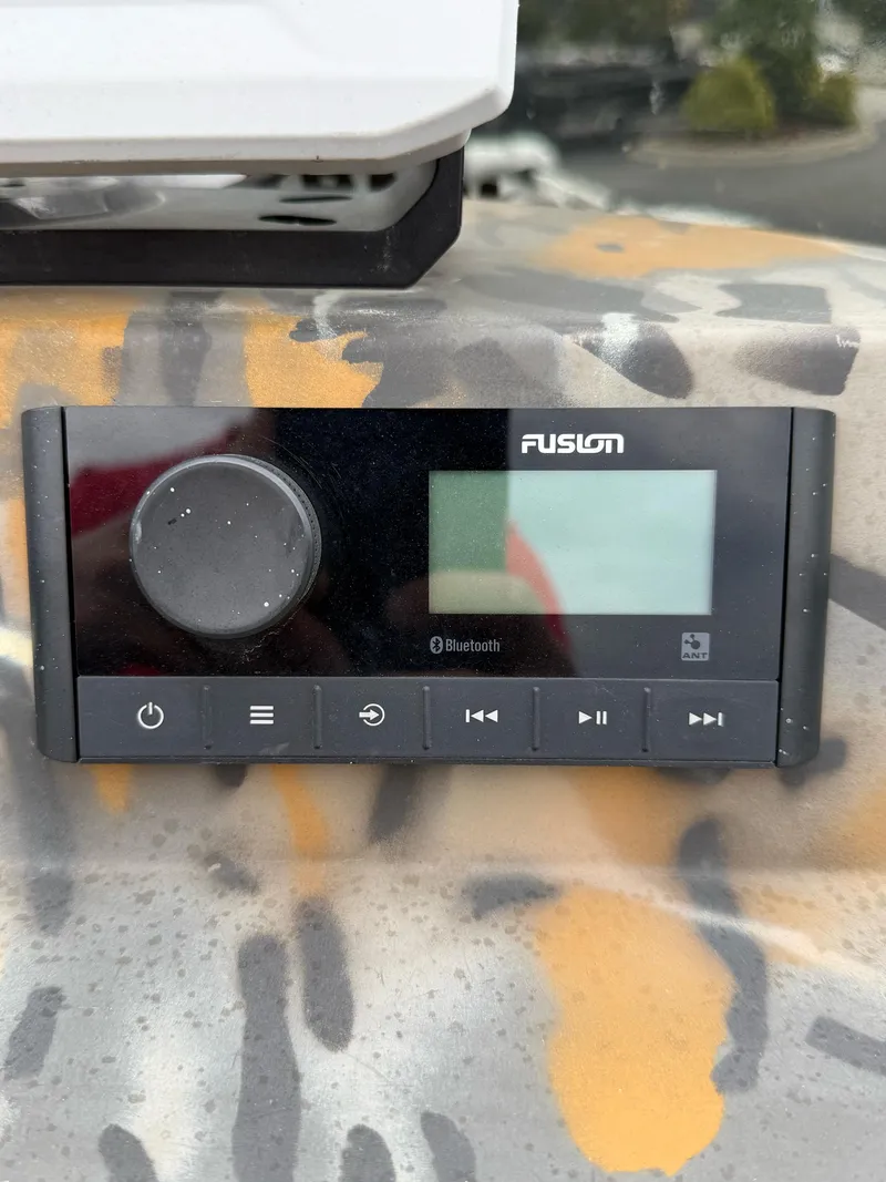 Slide: The Image of Fusion Bluetooth stereo system on 2022 War Eagle 961 Blackhawk boat dashboard. - 23