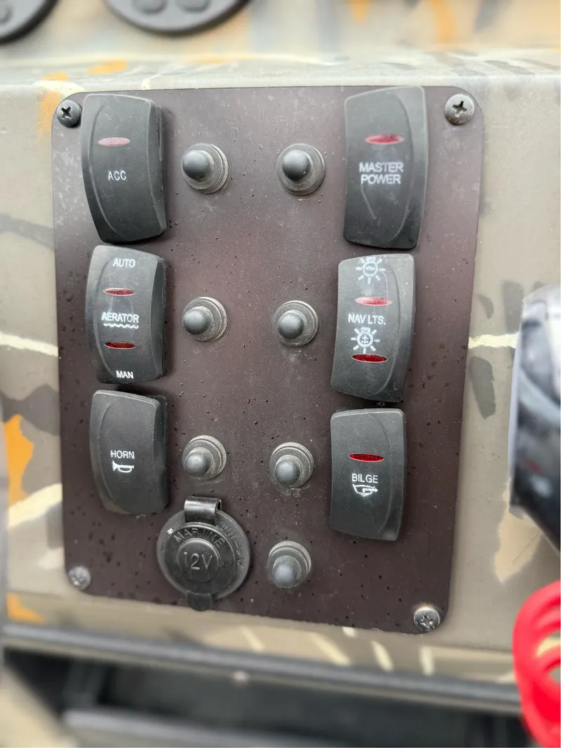Slide: The Image of Control panel of 2022 War Eagle 961 Blackhawk boat with various switches. - 25