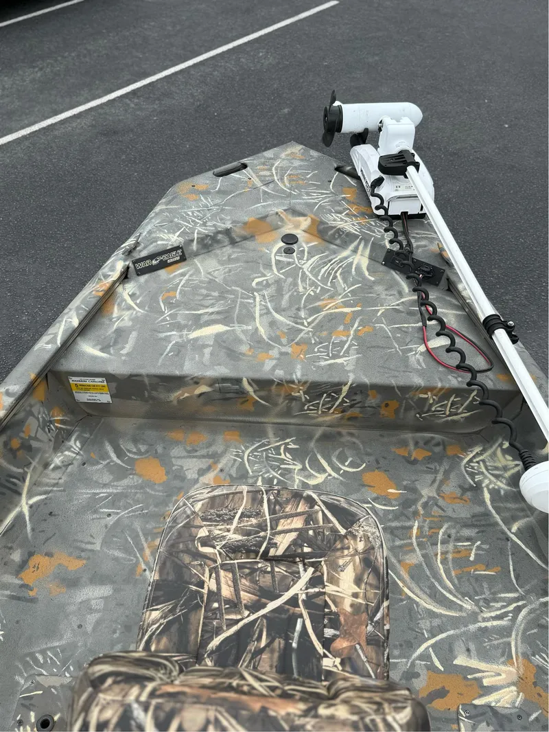 Slide: The Image of 2022 War Eagle 961 Blackhawk boat with camouflage design and trolling motor. - 29