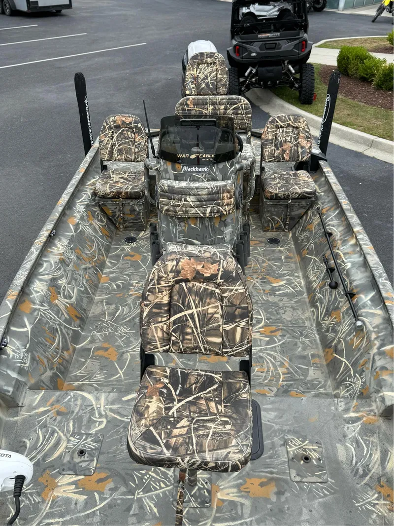Slide: The Image of 2022 War Eagle 961 Blackhawk boat with camouflage seating and interior design. - 30