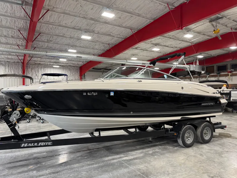 The Image of 2012 Monterey 264 FS boat on trailer in indoor storage facility. - 1