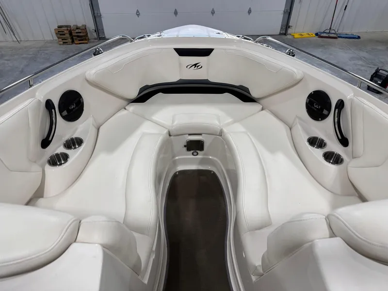 Slide: The Image of 2012 Monterey 264 FS boat interior with white seating and cup holders. - 10