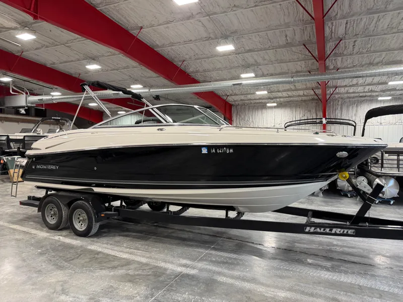 Slide: The Image of 2012 Monterey 264 FS boat on trailer in indoor showroom. - 2