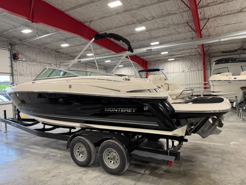 Slide: The Image of 2012 Monterey 264 FS boat on trailer in indoor storage facility. - 4