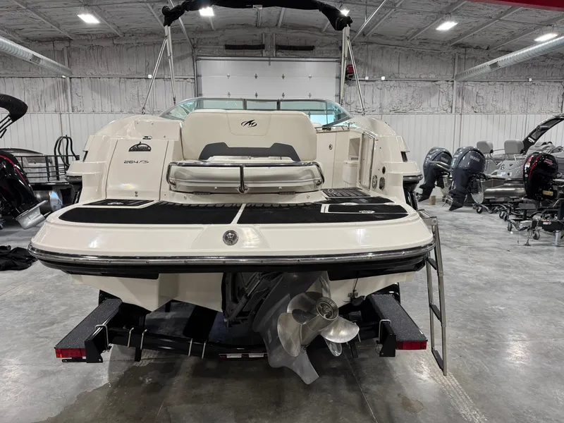 Slide: The Image of 2012 Monterey 264 FS boat in a garage, rear view with propeller and swim platform. - 5