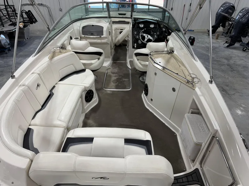 Slide: The Image of 2012 Monterey 264 FS boat interior with white seating and modern dashboard. - 6