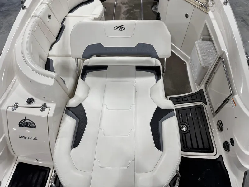 Slide: The Image of 2012 Monterey 264 FS boat interior with white seating and black accents. - 8