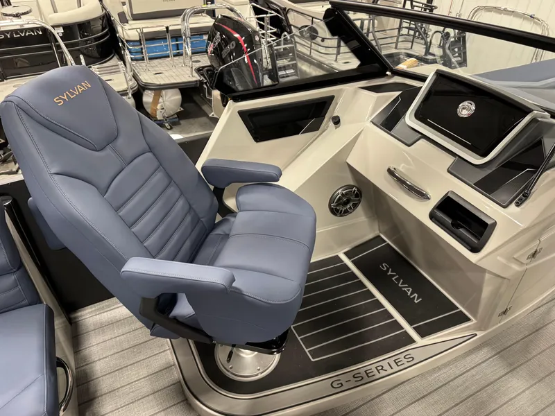 Slide: The Image of 2025 Sylvan G5 boat interior with blue captain's chair and modern dashboard. - 11