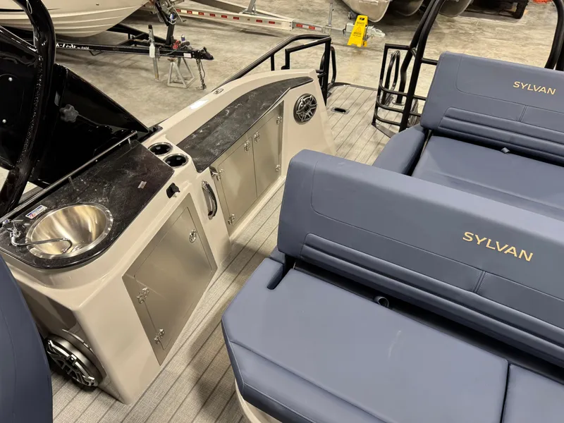 Slide: The Image of 2025 Sylvan G5 boat interior with seating and kitchenette area. - 14