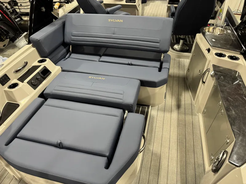 Slide: The Image of 2025 Sylvan G5 boat interior with blue seating and modern amenities. - 15