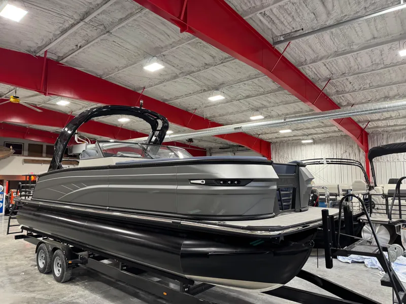 Slide: The Image of 2025 Sylvan G5 pontoon boat in showroom, featuring sleek design and modern amenities. - 2