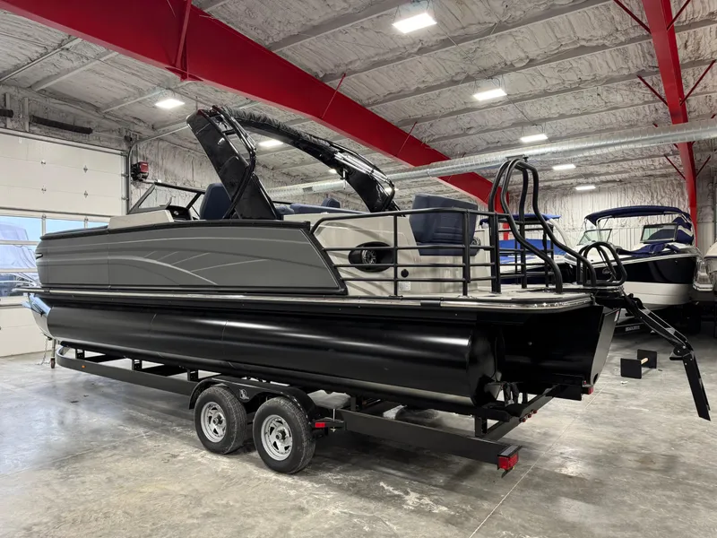 Slide: The Image of 2025 Sylvan G5 pontoon boat on trailer in indoor showroom. - 3