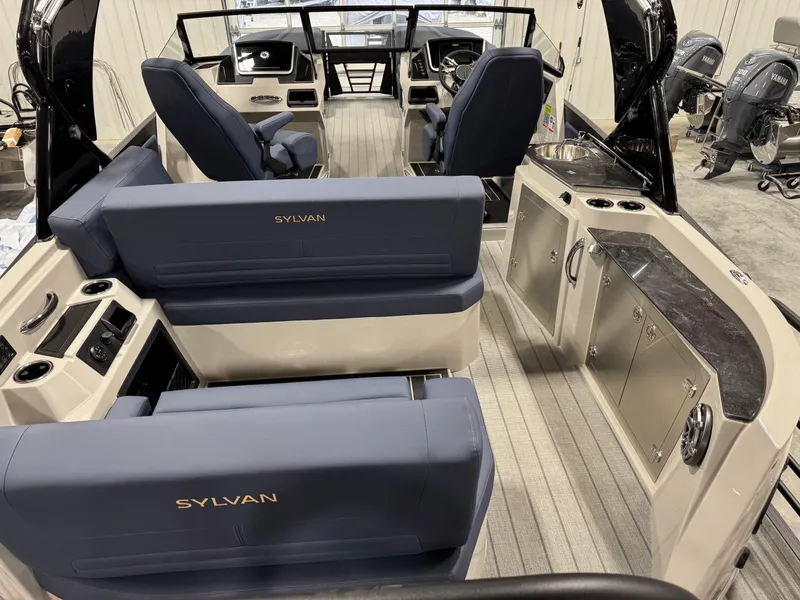 Slide: The Image of 2025 Sylvan G5 boat interior with blue seating and modern dashboard. - 7
