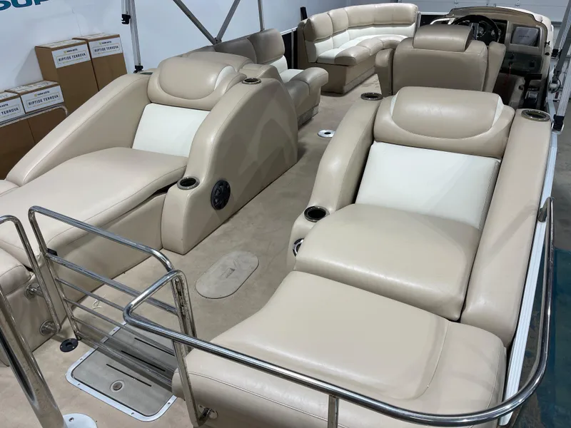 Slide: The Image of 2013 Bennington 22 R pontoon boat with beige leather seating and stainless steel railings. - 10