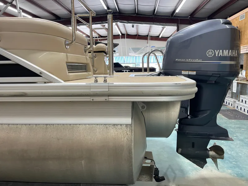 Slide: The Image of 2013 Bennington 22 R pontoon boat with Yamaha outboard motor in a warehouse. - 14