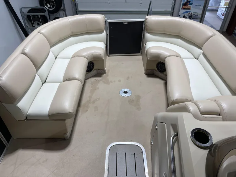 Slide: The Image of Luxurious seating on a 2013 Bennington 22 R pontoon boat, featuring beige and white upholstery. - 15