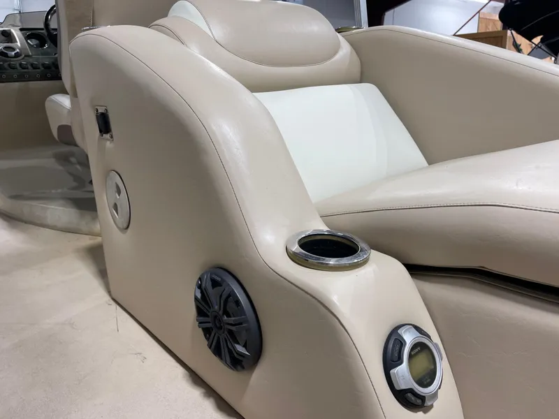 Slide: The Image of 2013 Bennington 22 R boat interior with beige seating, cup holder, and speaker. - 16