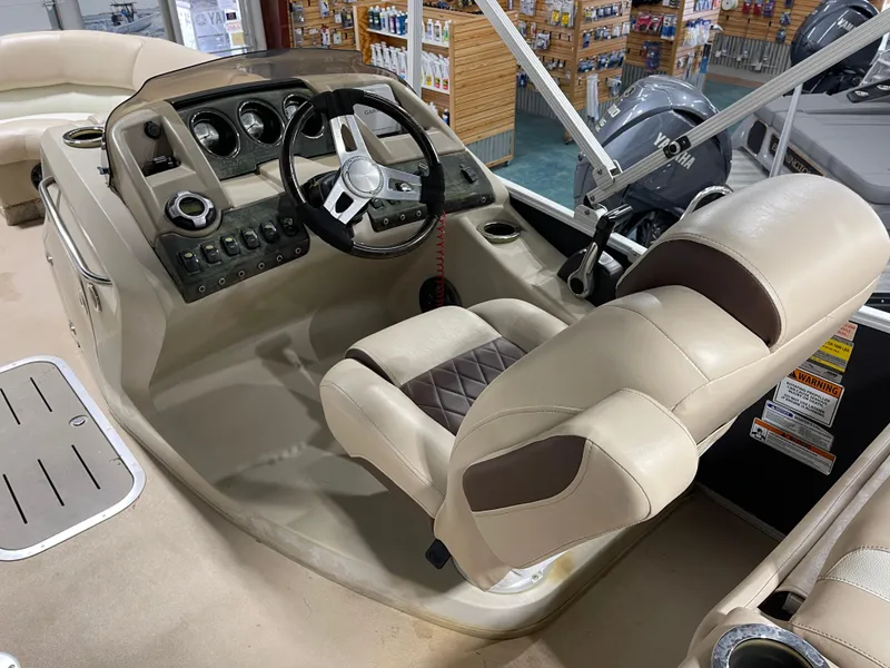 Slide: The Image of 2013 Bennington 22 R boat helm with steering wheel and control panel in showroom. - 17