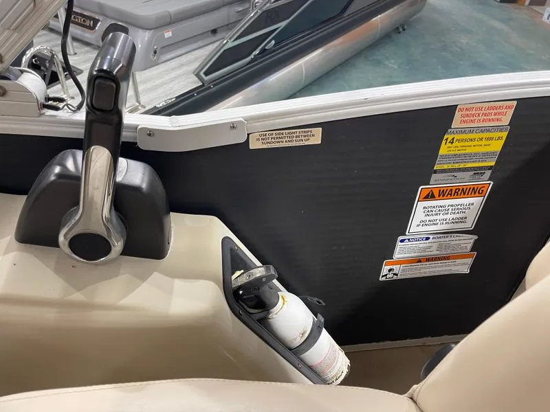 Slide: The Image of Control panel and safety warnings on a 2013 Bennington 22 R boat. - 21