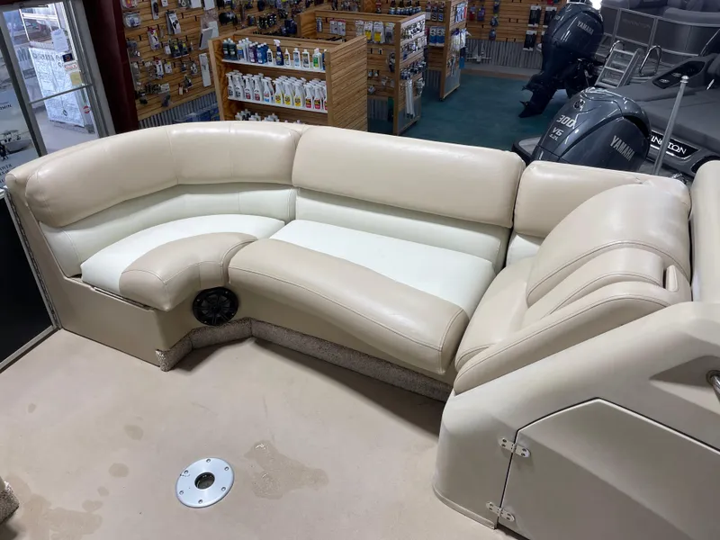 Slide: The Image of Luxurious seating on a 2013 Bennington 22 R boat, featuring cream leather upholstery. - 23