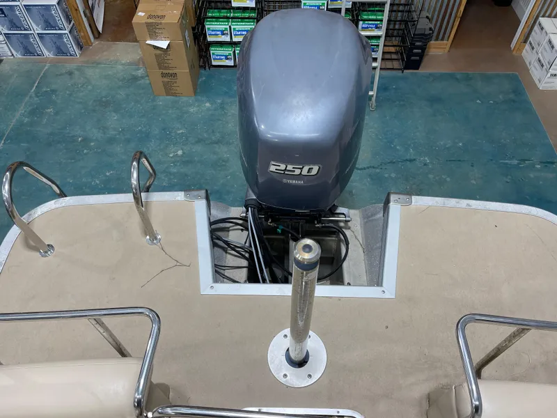 Slide: The Image of 2013 Bennington 22 R boat with Yamaha 250 outboard motor in a storage area. - 25