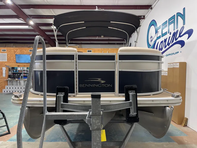 Slide: The Image of 2013 Bennington 22 R pontoon boat displayed indoors at Ocean Marine. - 5