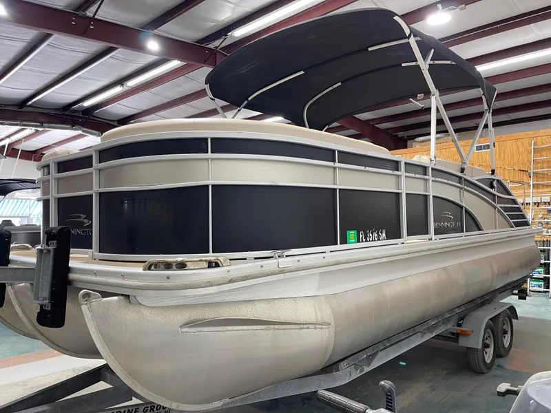 Slide: The Image of 2013 Bennington 22 R pontoon boat in indoor storage on a trailer. - 6
