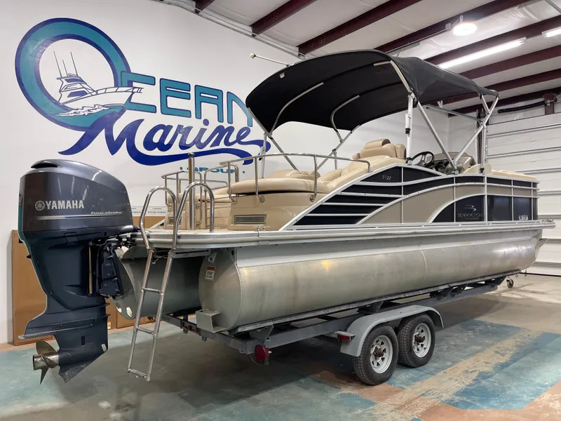 Slide: The Image of 2013 Bennington 22 R pontoon boat with Yamaha outboard motor in a showroom. - 8
