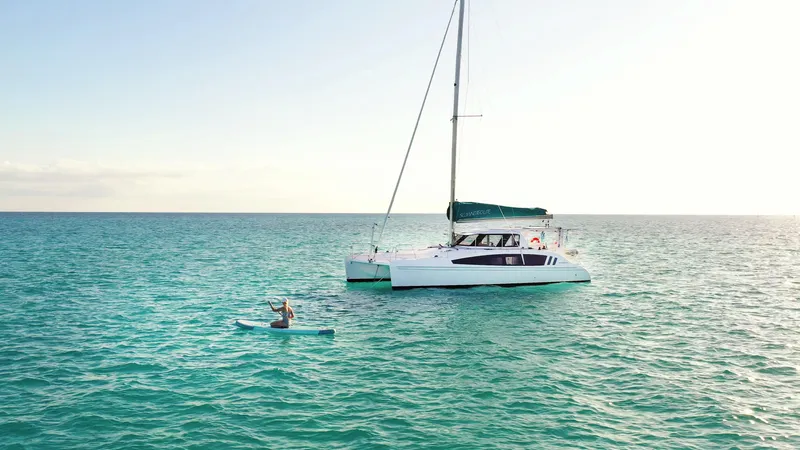 Slide: The Image of 2025 Seawind 1160 Lite catamaran sailing on calm ocean waters. - 1