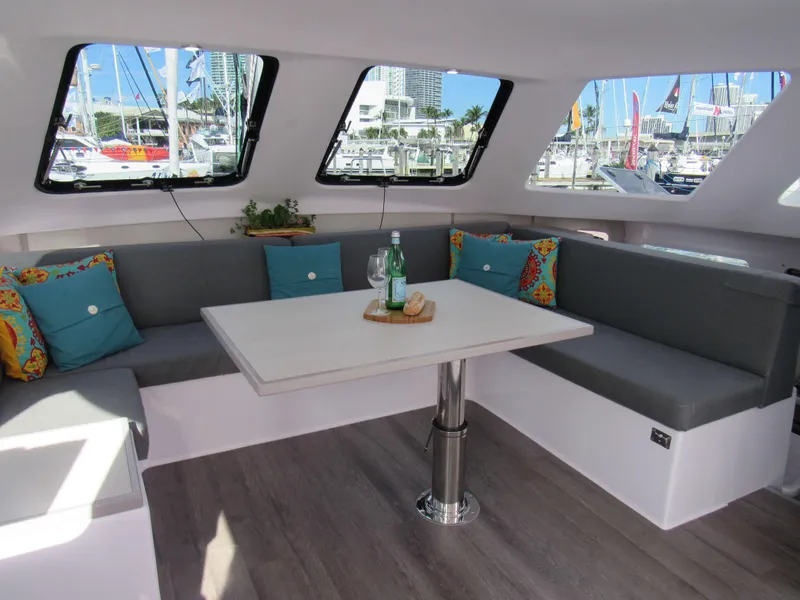 Slide: The Image of Interior of 2025 Seawind 1160 Lite catamaran with modern seating and table. - 4