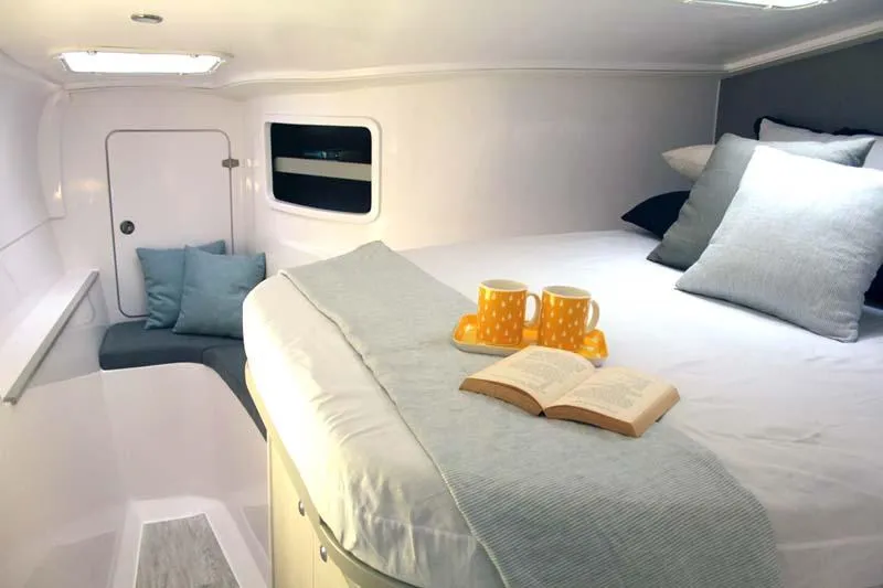 Slide: The Image of Cozy cabin interior of 2025 Seawind 1160 Lite with bed, pillows, and mugs. - 6