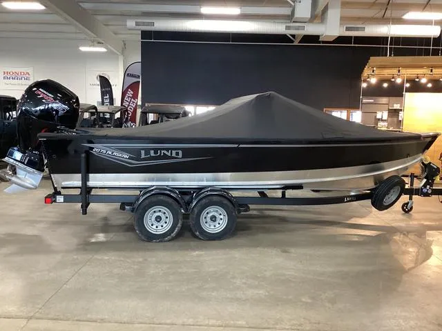Slide: The Image of 2024 Lund 2075 Alaskan Sport boat with cover on trailer in showroom. - 1
