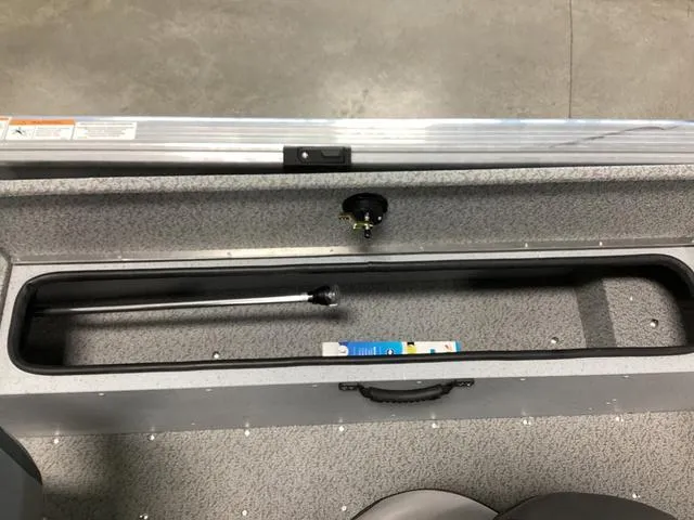 Slide: The Image of 2024 Lund 2075 Alaskan Sport boat storage compartment with rod holder and accessories. - 10