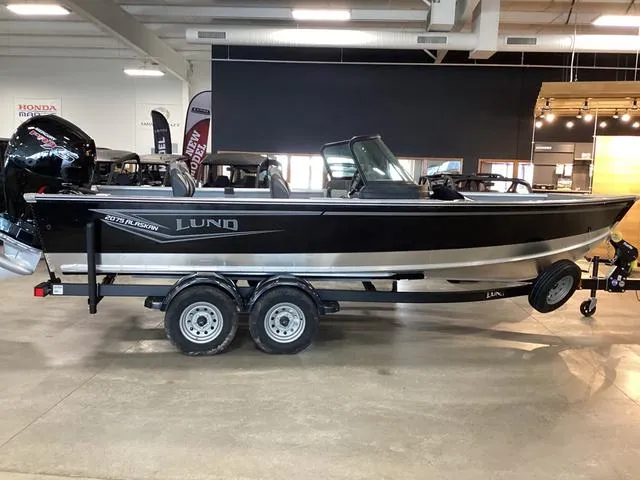 Slide: The Image of 2024 Lund 2075 Alaskan Sport boat on trailer in showroom. - 2