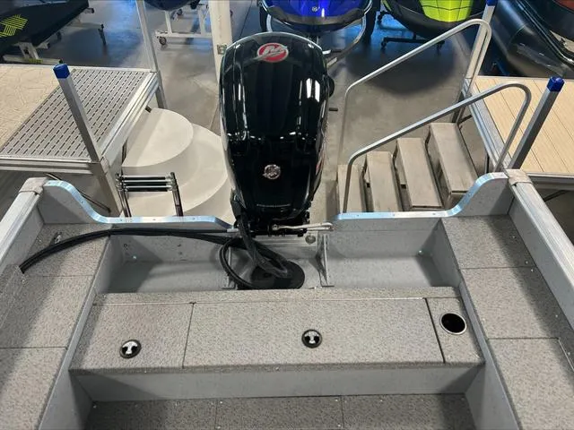 Slide: The Image of 2024 Lund 1875 Alaskan DC boat with outboard motor, viewed from the rear deck. - 11