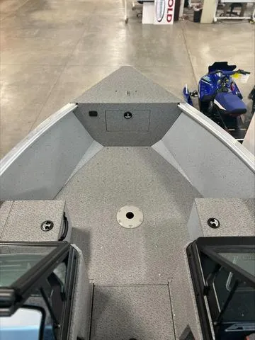 Slide: The Image of 2024 Lund 1875 Alaskan DC boat interior, showcasing spacious deck and storage compartments. - 16