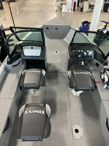 Slide: The Image of 2024 Lund 1875 Alaskan DC boat interior with dual consoles and branded seating. - 17