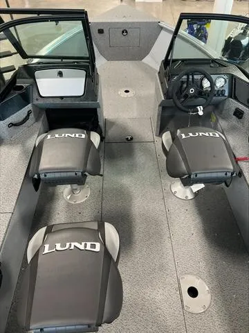 Slide: The Image of 2024 Lund 1875 Alaskan DC boat interior with dual seats and steering console. - 18