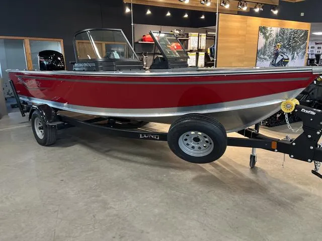 Slide: The Image of 2024 Lund 1875 Alaskan DC boat in showroom, red exterior, on trailer. - 3