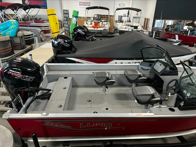 Slide: The Image of 2024 Lund 1875 Alaskan DC boat in showroom, featuring Mercury Pro XS engines. - 7