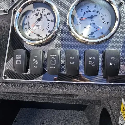 Slide: The Image of Dashboard of 2025 Lund 1775 Adventure Sport boat with gauges and control switches. - 10