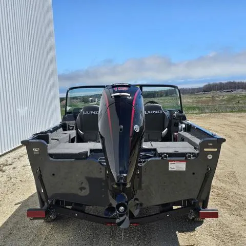 Slide: The Image of 2025 Lund 1775 Adventure Sport boat, rear view, parked outdoors on a sunny day. - 4